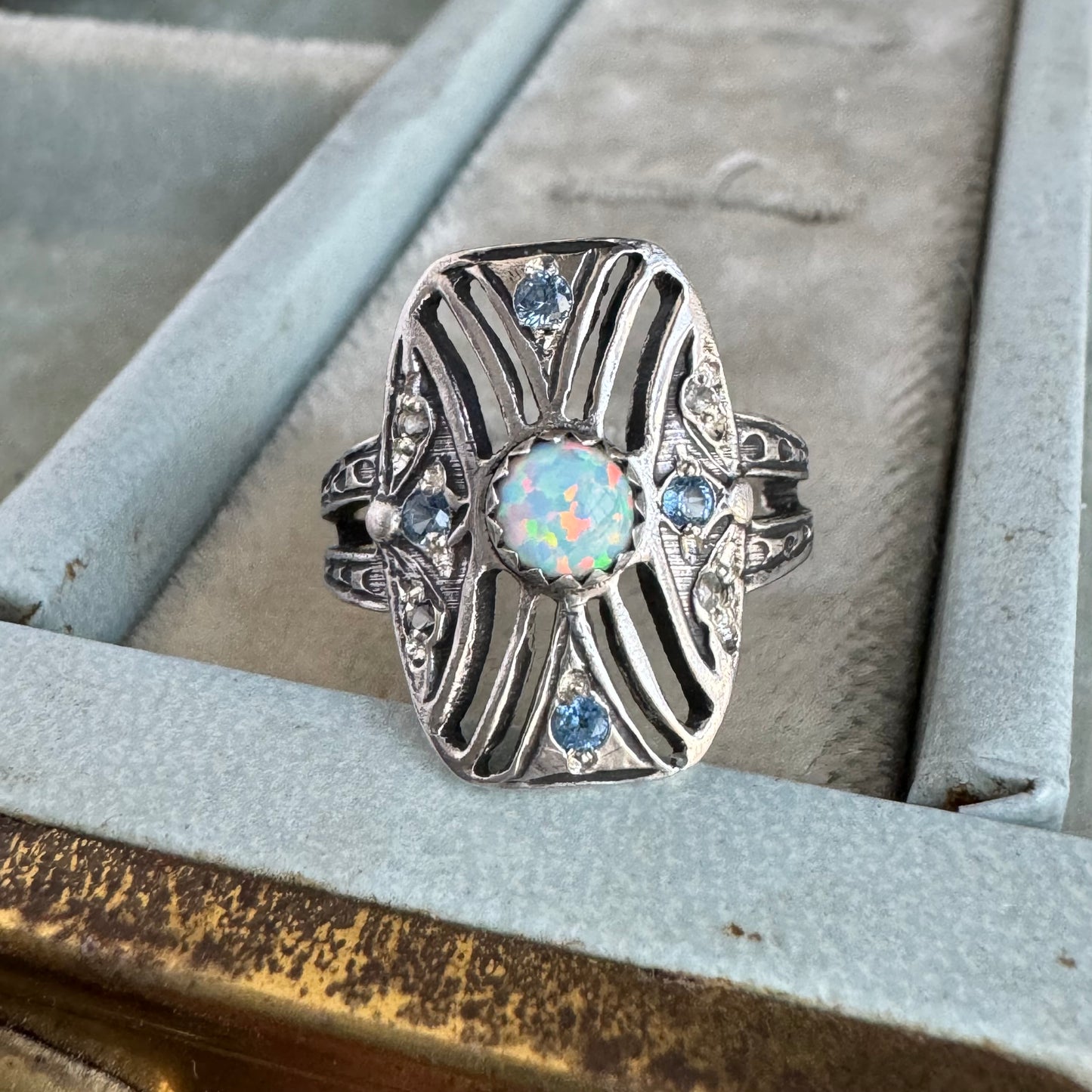 Art Deco Kyocera Opal, Blue Zircon, and White Sapphire artisan cigar band cocktail ring in Sterling Silver