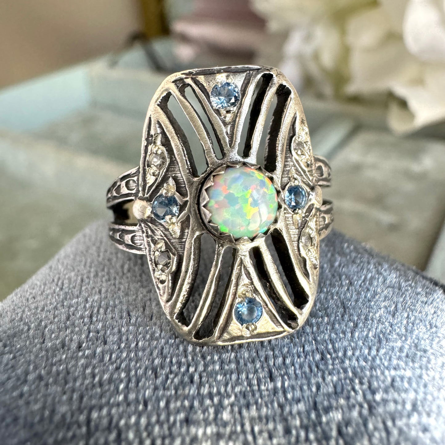 Art Deco Kyocera Opal, Blue Zircon, and White Sapphire artisan cigar band cocktail ring in Sterling Silver